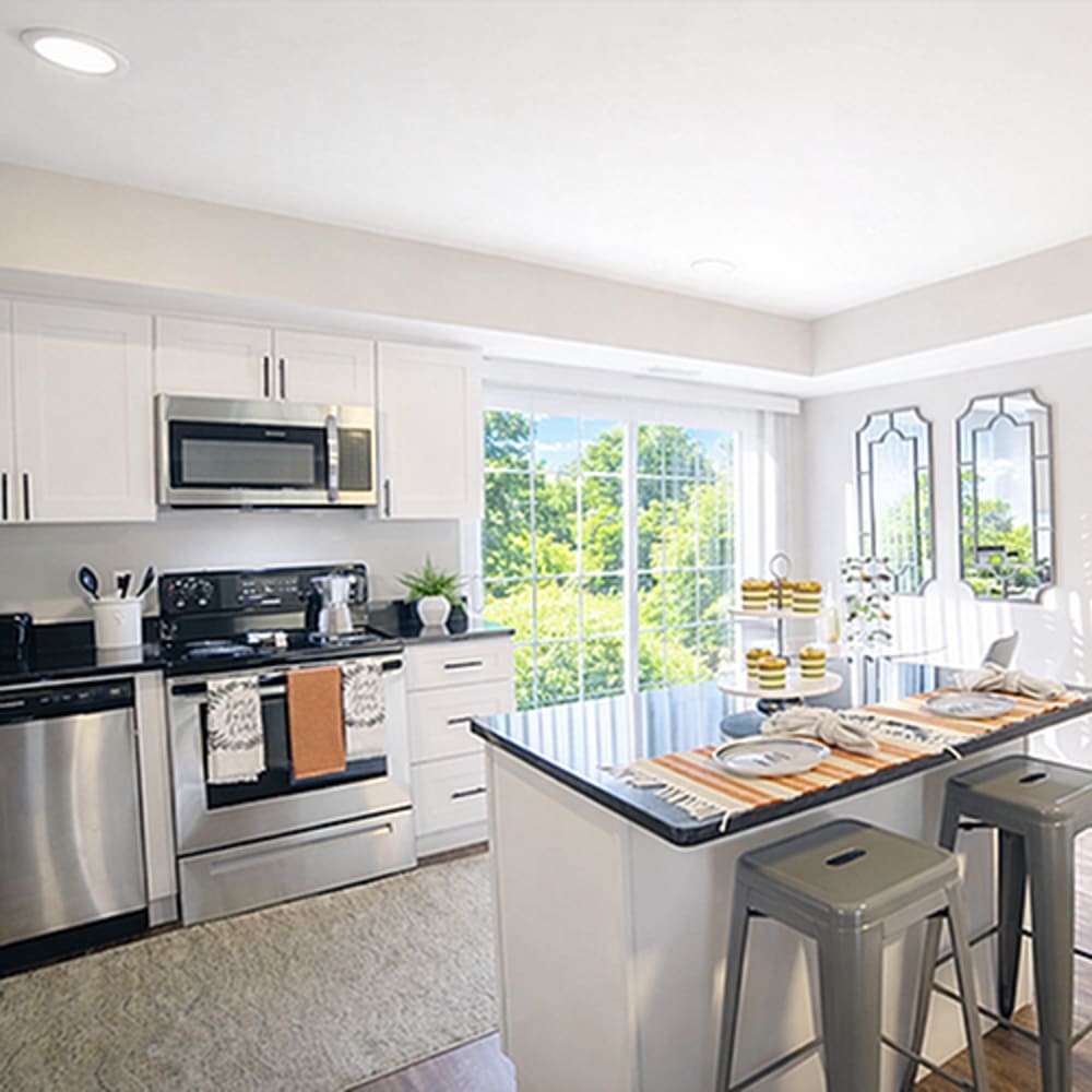 Stylish kitchen island with seating at 83 West Townhomes in West Bloomfield Township, Michigan