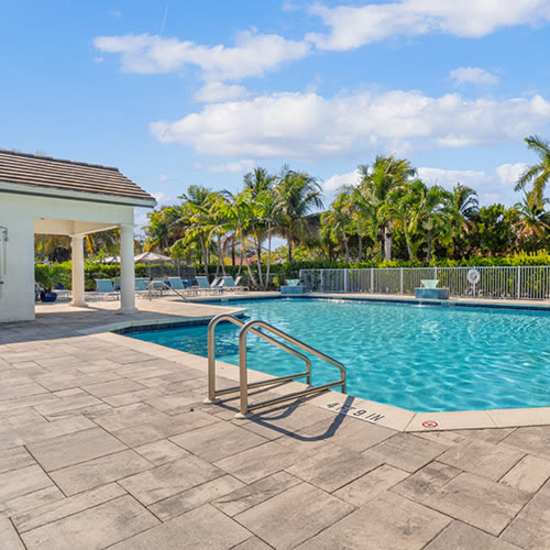 A resort style swimming pool with sparkling clean water at Amberton Luxury Townhomes in Naples, Florida