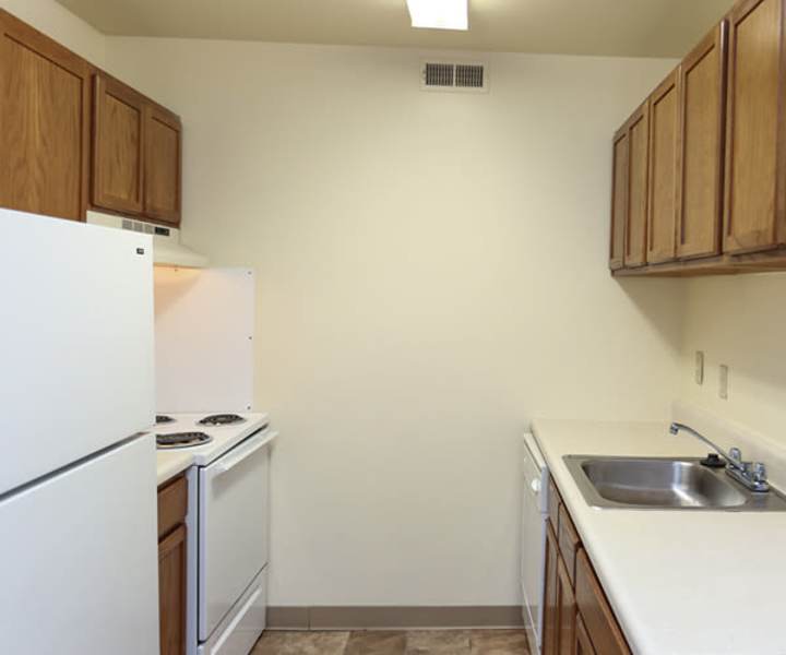 Interior of a modern apartment kitchen with appliances at Landmark Apartments in Chesapeake, Virginia