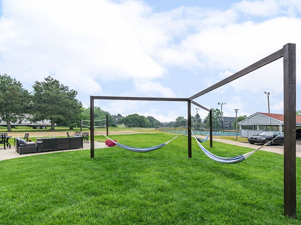 Hammocks in green lawn area with seating nearby at Runaway Bay in Lansing, Michigan