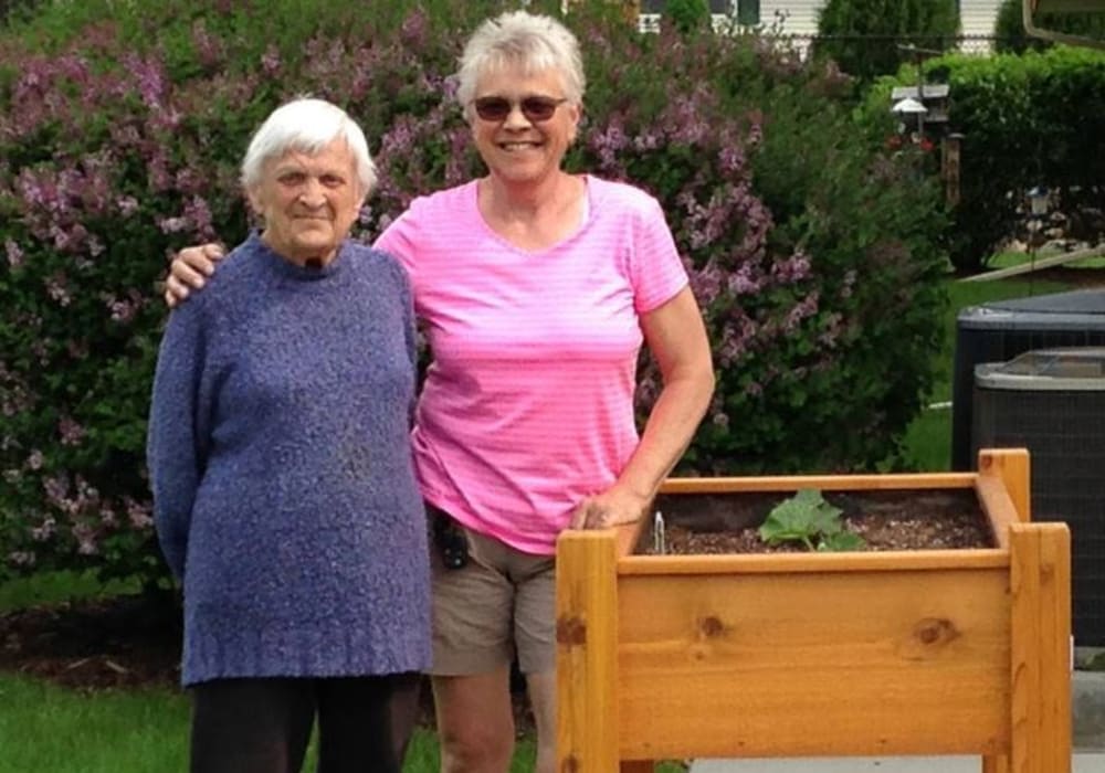 Residents standing at the volunteer garden at Wellington Place at Hartford in Hartford, Wisconsin