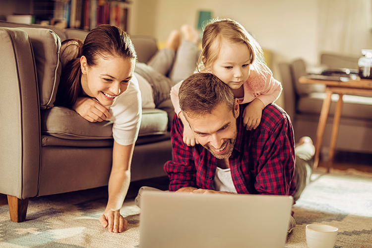 Family surfing the web in their beautiful living room at Brookview Manor Apartments in Stratford, New Jersey