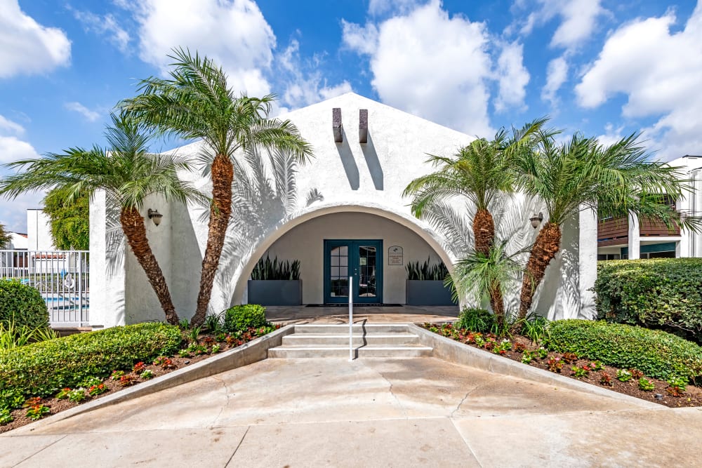The leasing office entryway surrounded palm trees at Kendallwood Apartments in Whittier, California