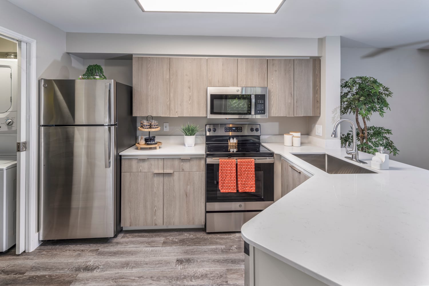 View of kitchen with stainless steel appliances at Redmond Place Apartments in Redmond, Washington