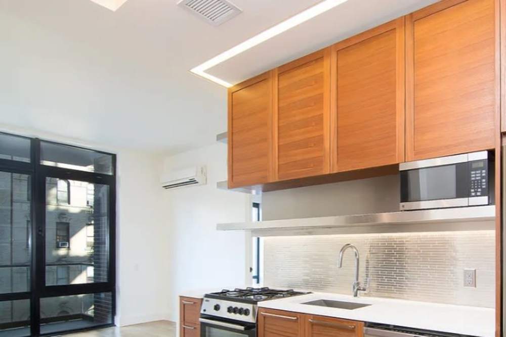 Kitchen with wood cabinetries at The Garnett in Brooklyn, New York