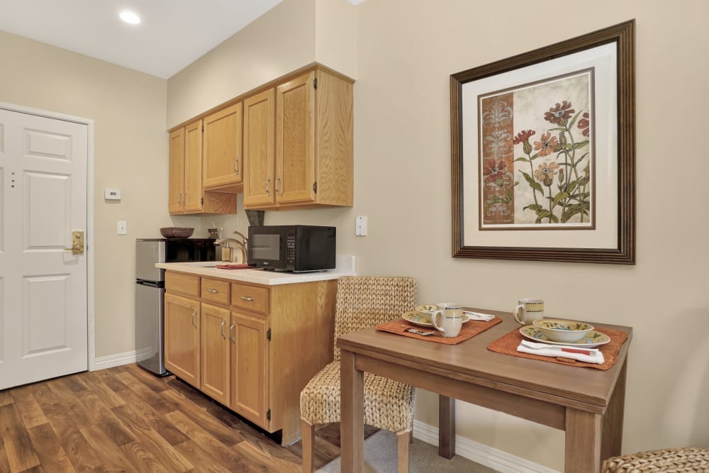 Senior apartment kitchen with wood acents at Chancellor Gardens in Clearfield, Utah