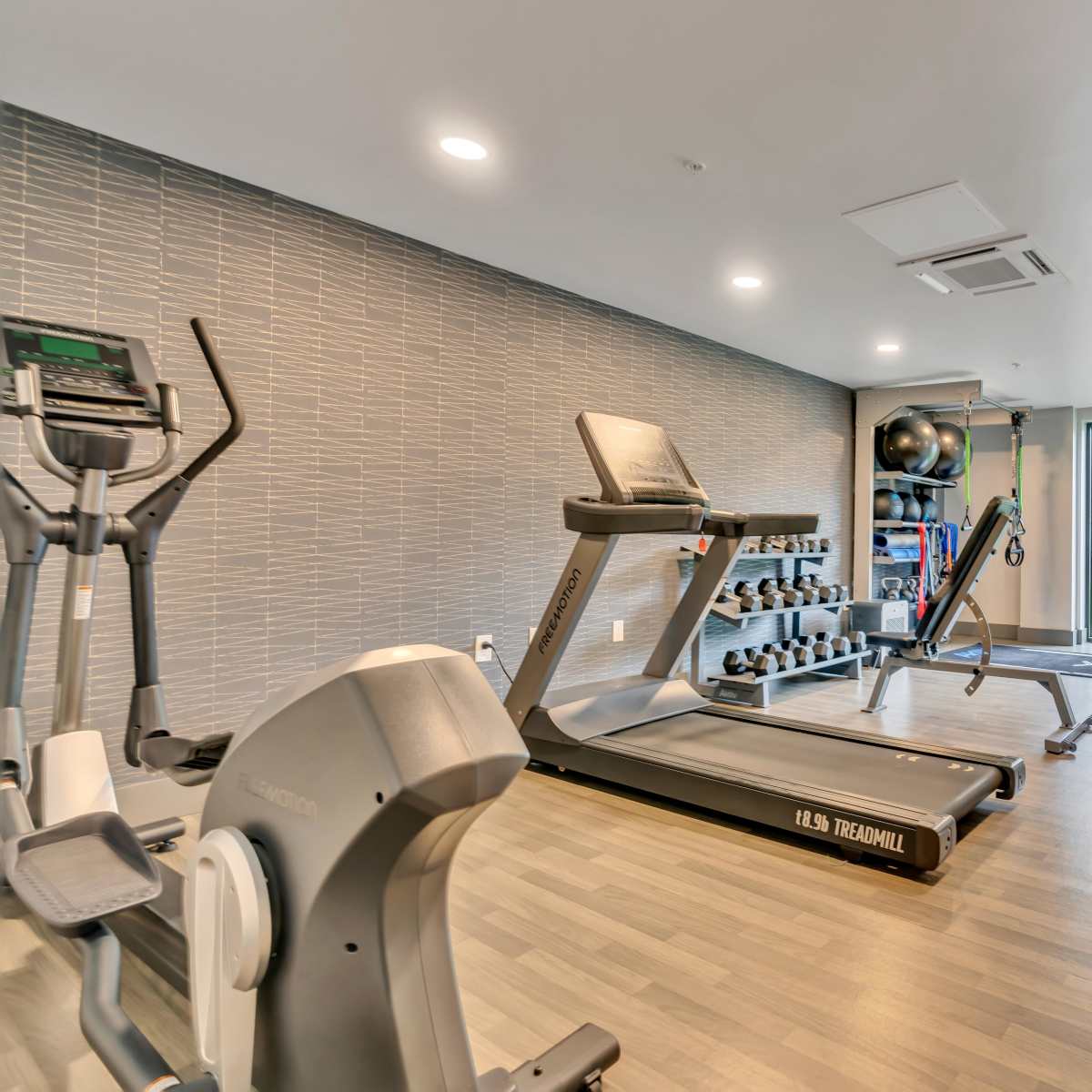 Exercise equipment with weights and mats at Latitude at South Portland in Portland, Maine