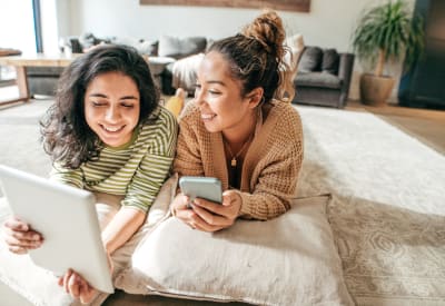Residents looking at school options online in their new home at Vail Quarters in Dallas, Texas