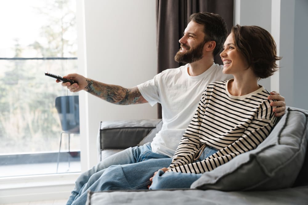 Couple watching TV at The Everstead at Windrose in Spring, Texas