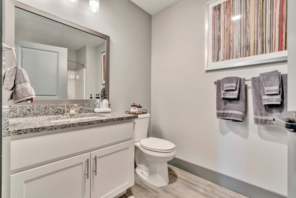 Granite countertop with sink and mirror at Latitude at South Portland in Portland, Maine