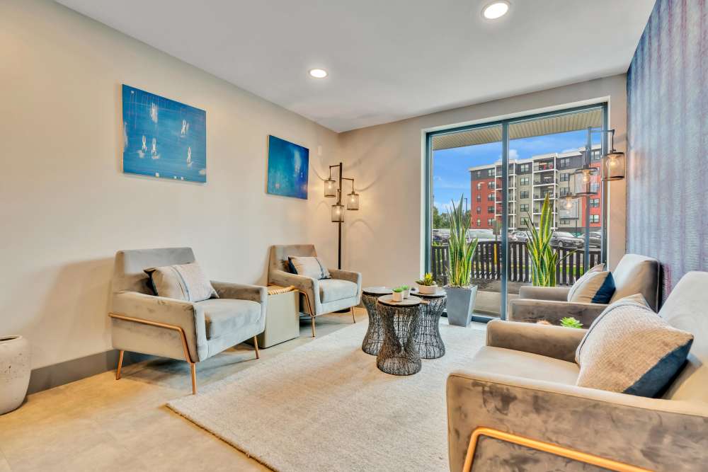 Two chairs and a table in a living area at Latitude at South Portland in Portland, Maine