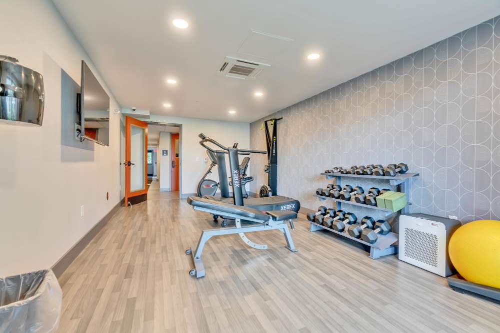Exercise equipment and weights in room at Latitude at South Portland in Portland, Maine