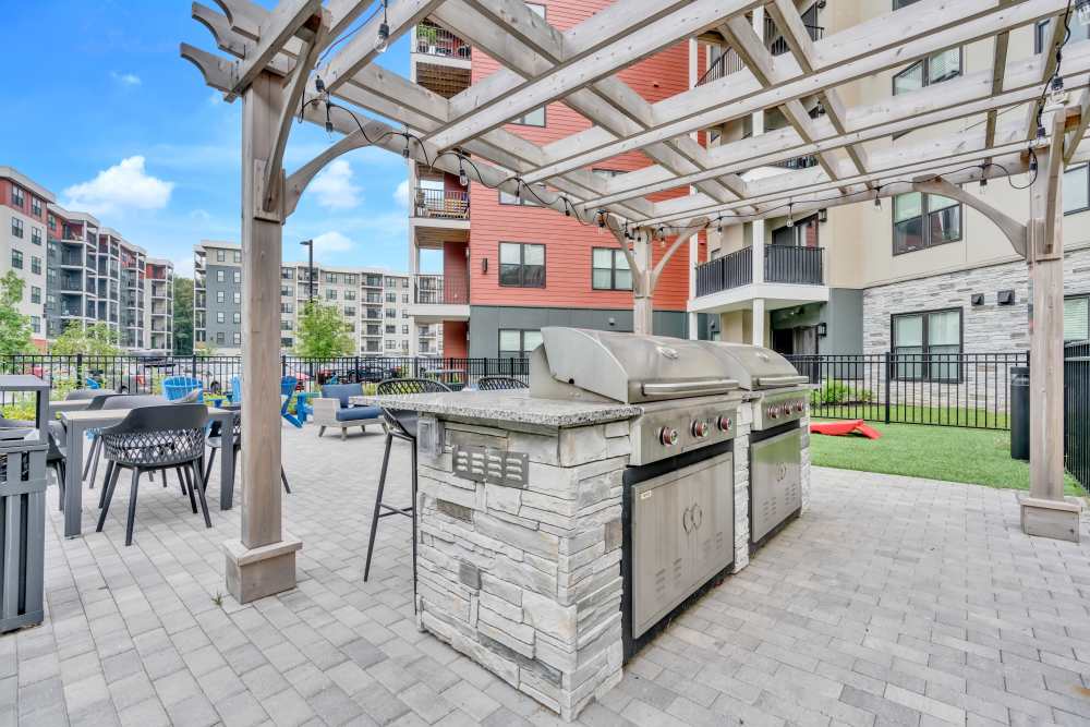 Grilling station with seating area at Latitude at South Portland in Portland, Maine