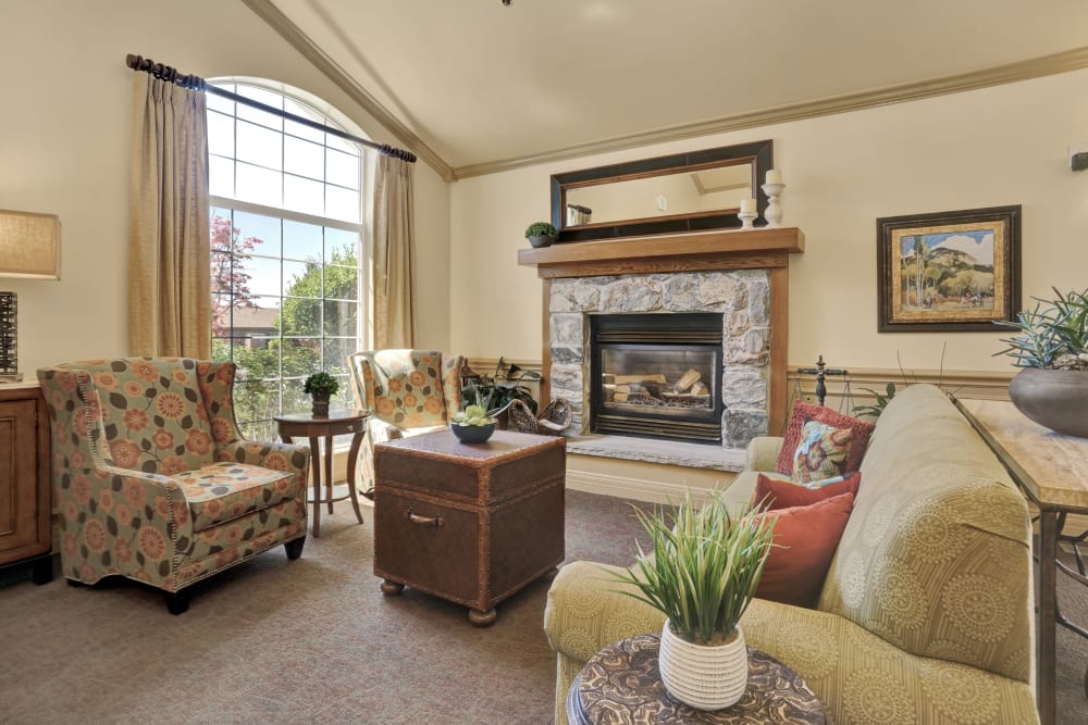 Elegant sitting room with fireplace at Chancellor Gardens in Clearfield, Utah
