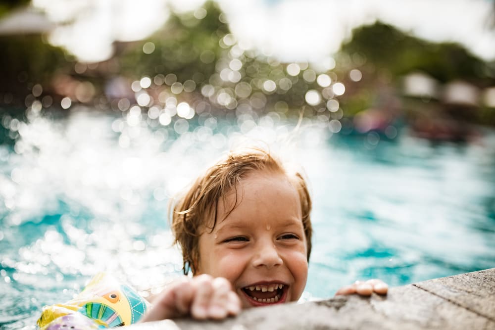 A young boy enjoying the swimming pool at Walnut Grove Landing Apartments in Vancouver, Washington