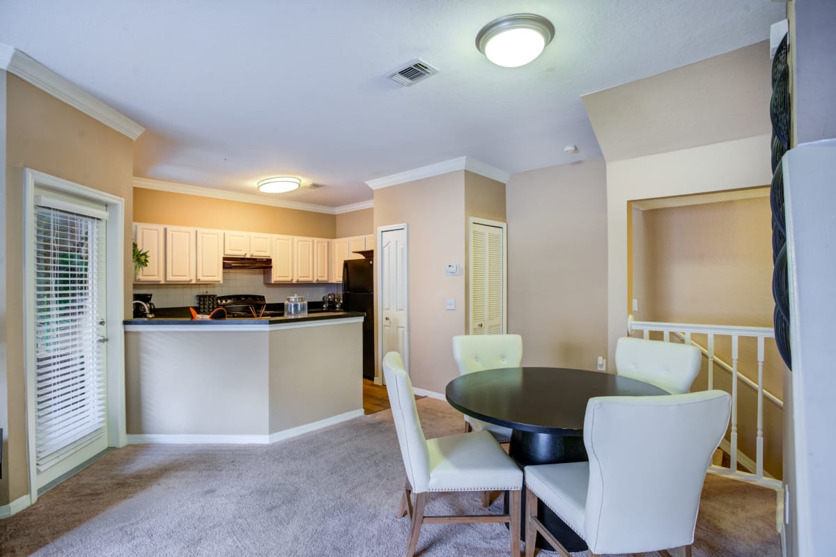 Spacious living room with plush carpeting at Amara at MetroWest in Orlando, Florida