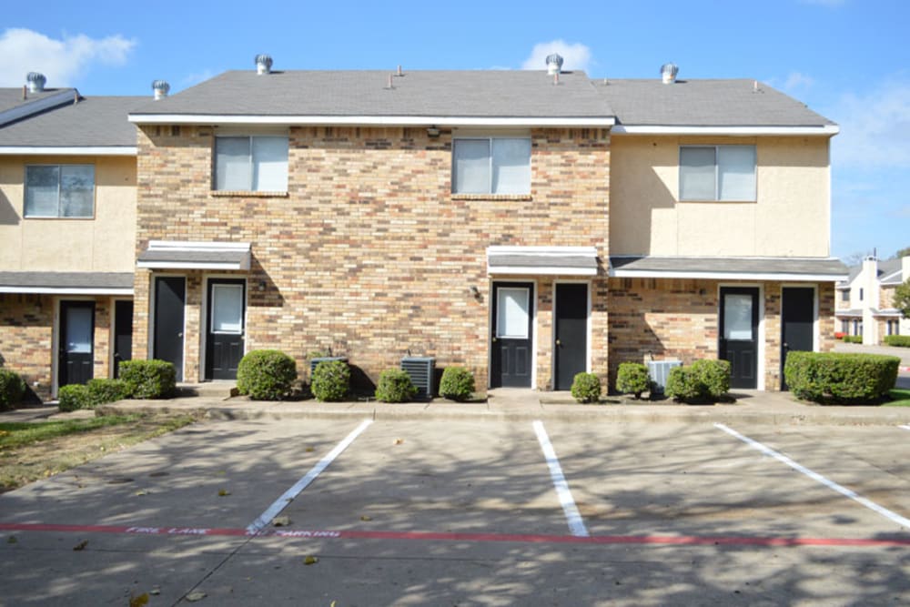 Parking lot and exterior view of the apartments at Highland Oaks in Duncanville, Texas