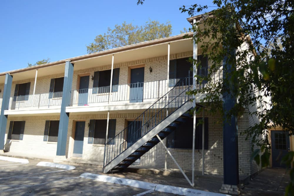 Exterior and front view of the apartments at Hampton Village in DeSoto, Texas