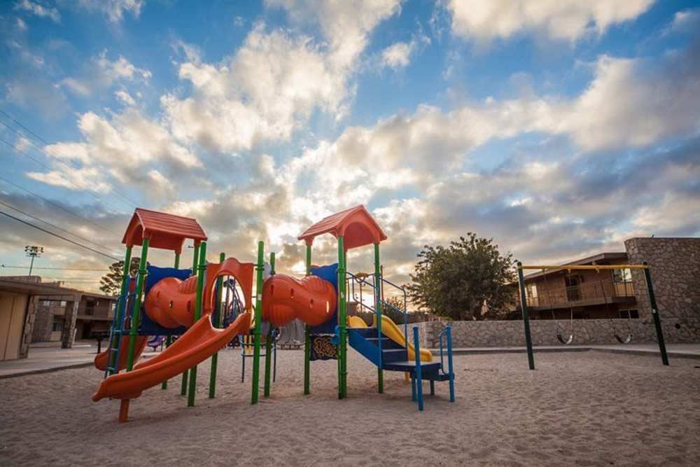 Playground with sliders at Agave Courtyard in El Paso, Texas 