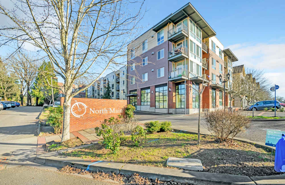 Exterior view of an apartment with location sign board at North Main Village in Milwaukie, Oregon