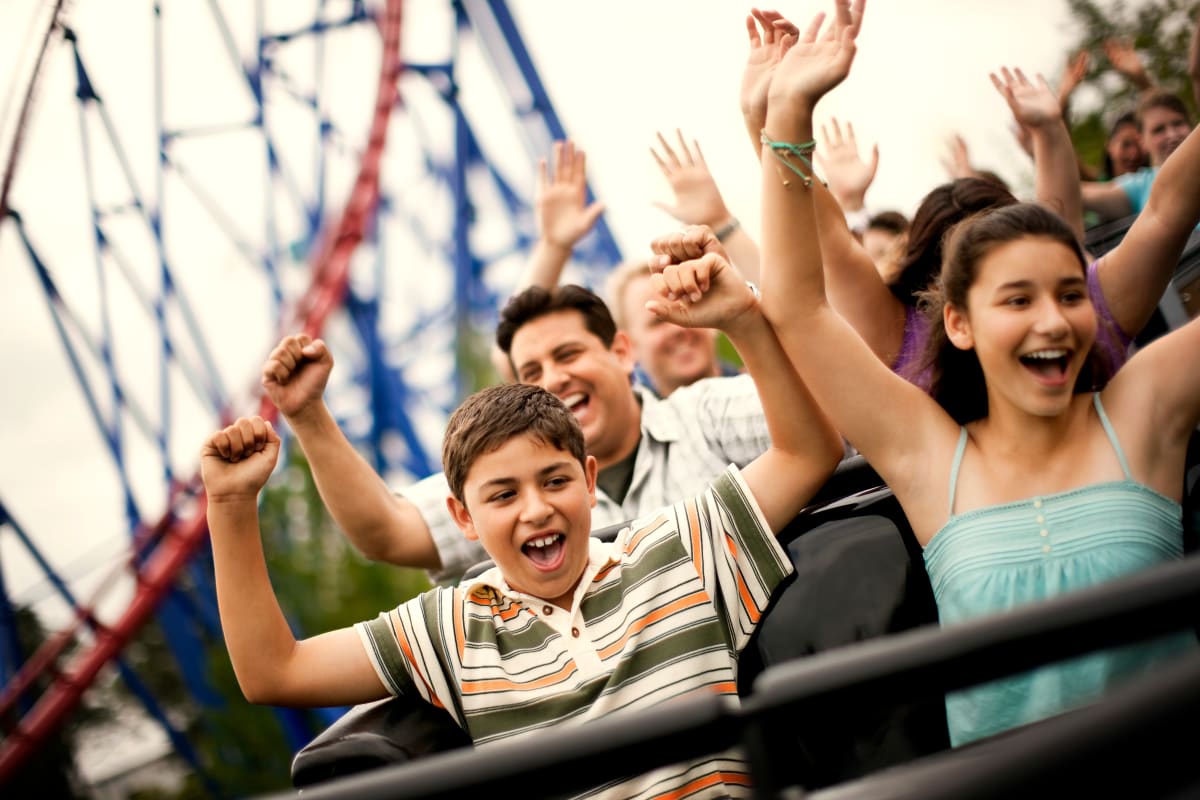 People enjoying a rollercoaster ride near Encasa Norwalk in Norwalk, California