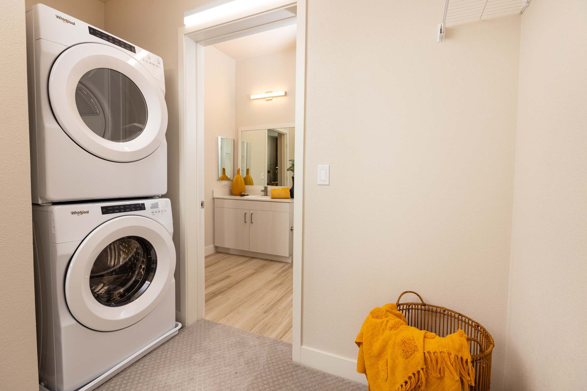 Laundry room with stackable washer and dryer at Solasta in Sacramento, California