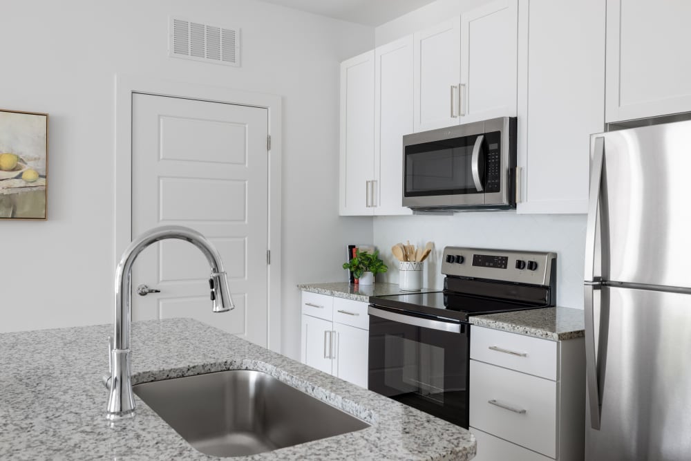 Model kitchen with stainless-steel appliances at The Archer In Acworth in Acworth, Georgia