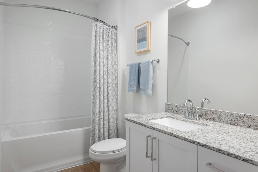 Model bathroom with granite countertops at The Archer In Acworth in Acworth, Georgia