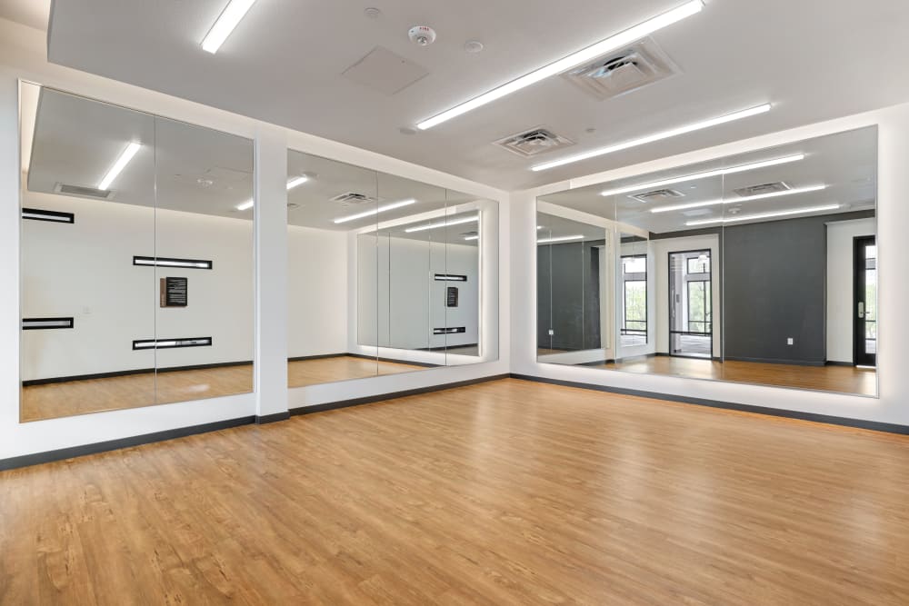 A workout room with mirrors at Marq Promenade in Westminster, Colorado