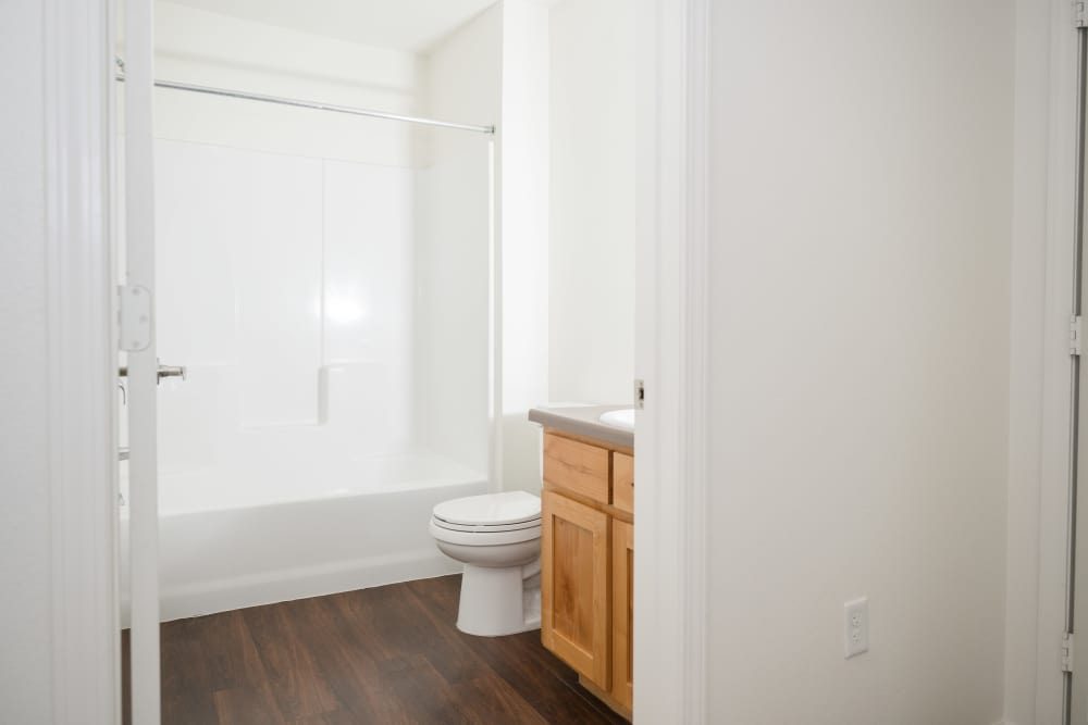 Bright and inviting bathroom featuring modern fixtures and elegant wood cabinetry at Cascade Villas in Wichita Falls, Texas.