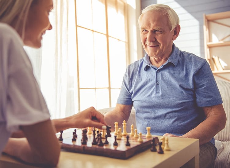 A resident partaking in a particularly exciting and competitive chess match at Alderbrook Village in Arkansas City, Kansas.