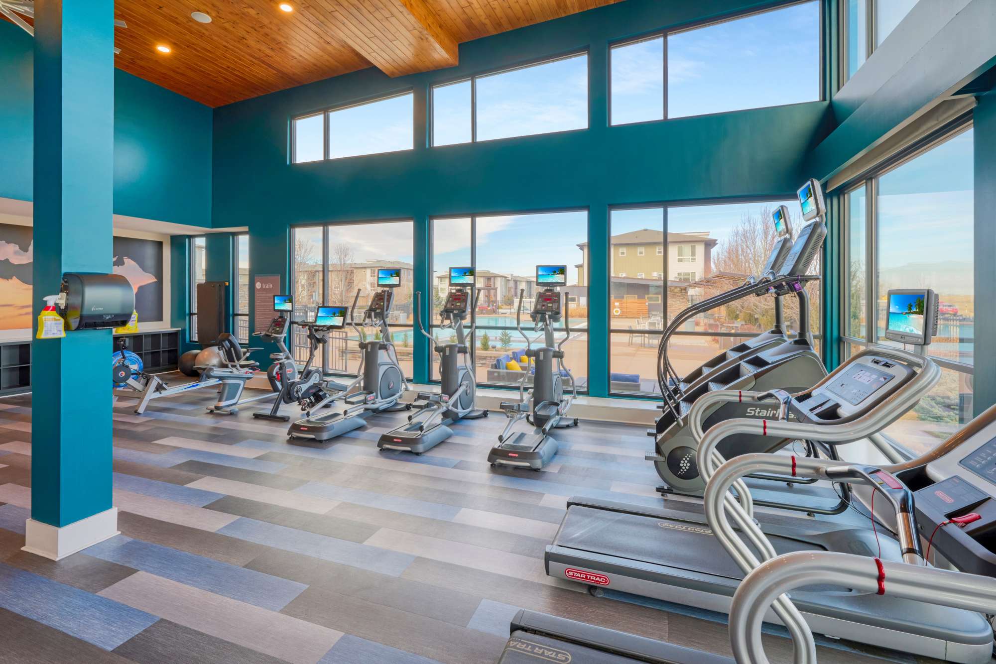 Fitness Center with Large Windows Overlooking the Pool at Strata Apartments in Denver, Colorado