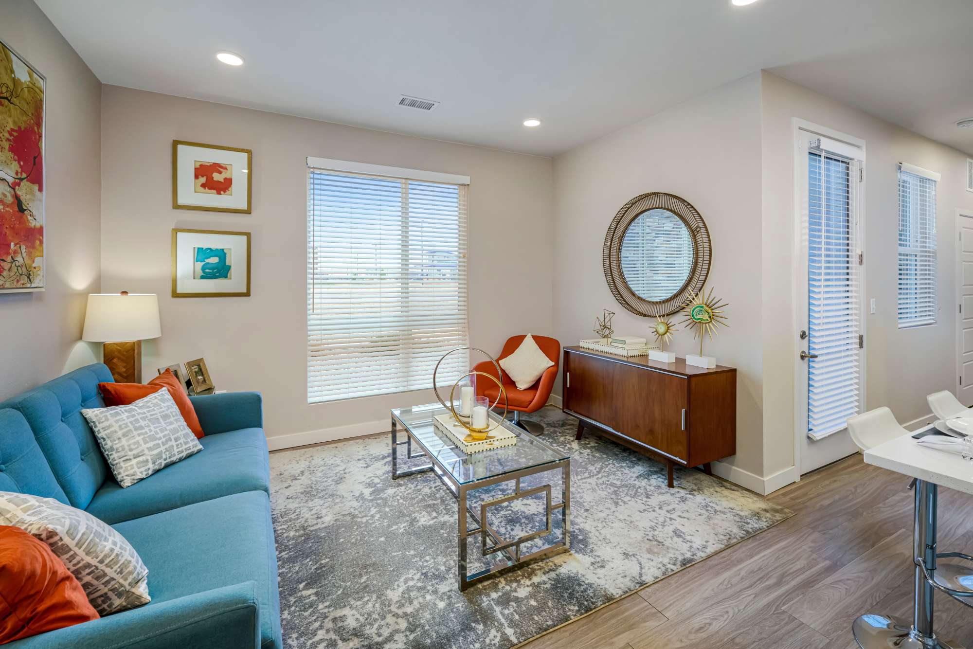 Spacious living room and kitchen with hardwood flooring in a home at Strata Apartments in Denver, Colorado