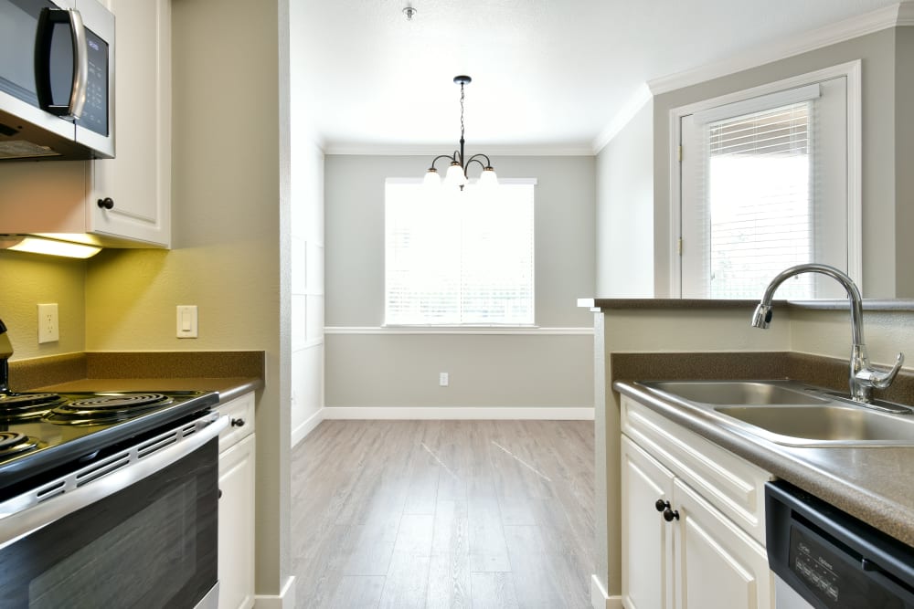 Kitchen and spacious living room at Emerald Park Apartment Homes in Dublin, California