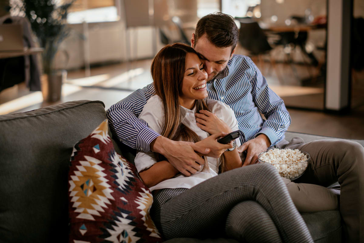 Couple sitting on a couch at Fennaway Green in Cazenovia, New York