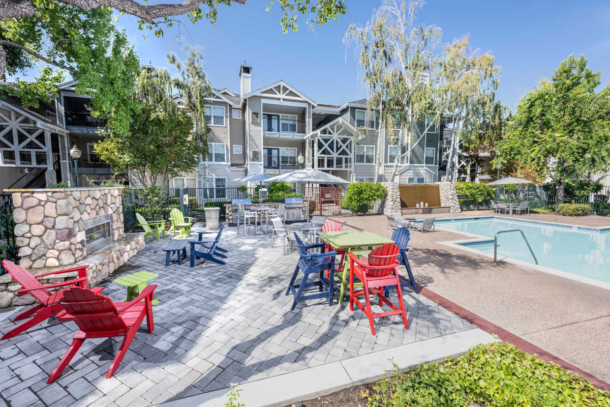Barbeque area near pool with seating at Nantucket Apartments in Santa Clara, California