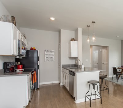 Modern and well-equipped kitchen in Woodland Acres Townhomes model home
