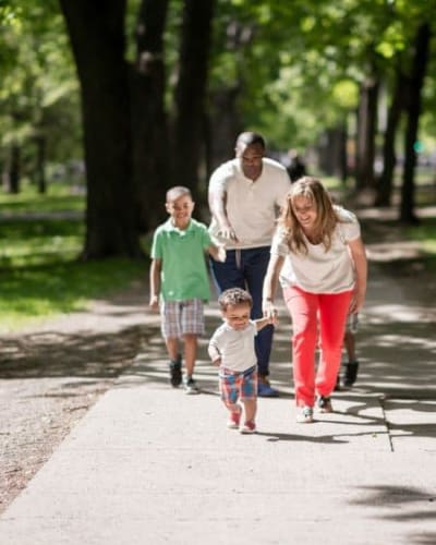 Resident family taking a stroll at a park near GrandeVille at Malta in Malta, New York