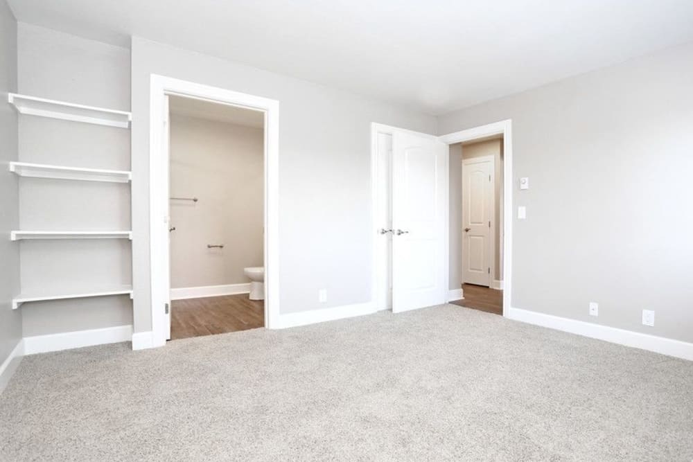 Model bedroom with built in shelves and plush carpets at Summerhill Terrace Apartment Homes in San Leandro, California