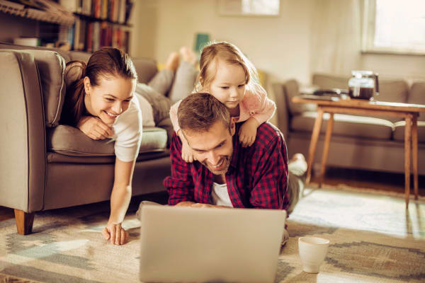 Happy family in the living room together at Jackson House Apartments