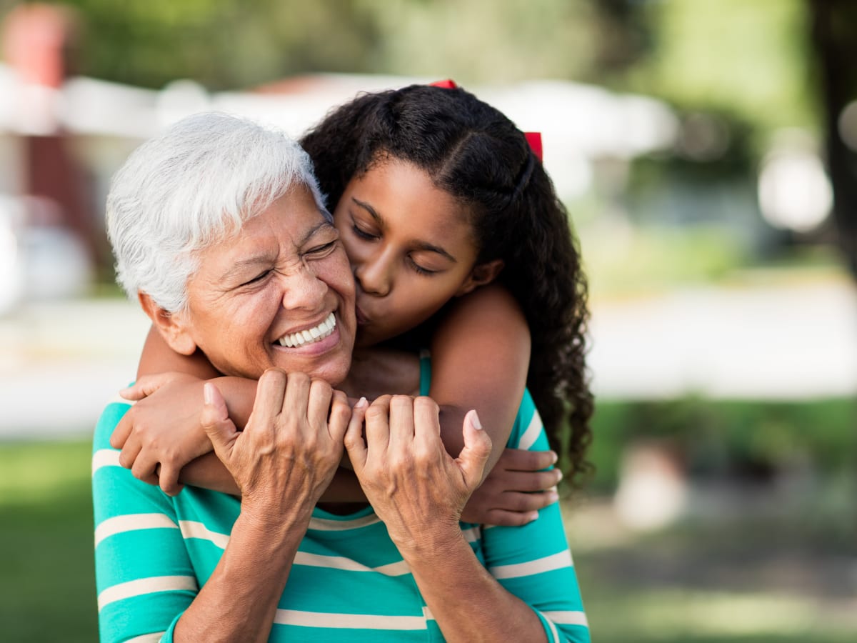 A resident being hugged by her young niece at Brightwater Senior Living in Bend, Oregon