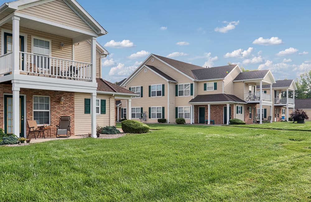 Exterior with private patio and lush lawn at Westview Commons Apartments in Rochester, New York
