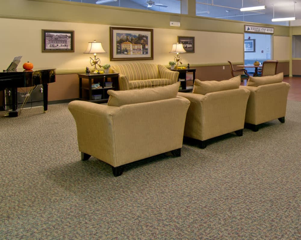 Cozy lounge area with a piano at Heritage Hall in Centralia, Missouri