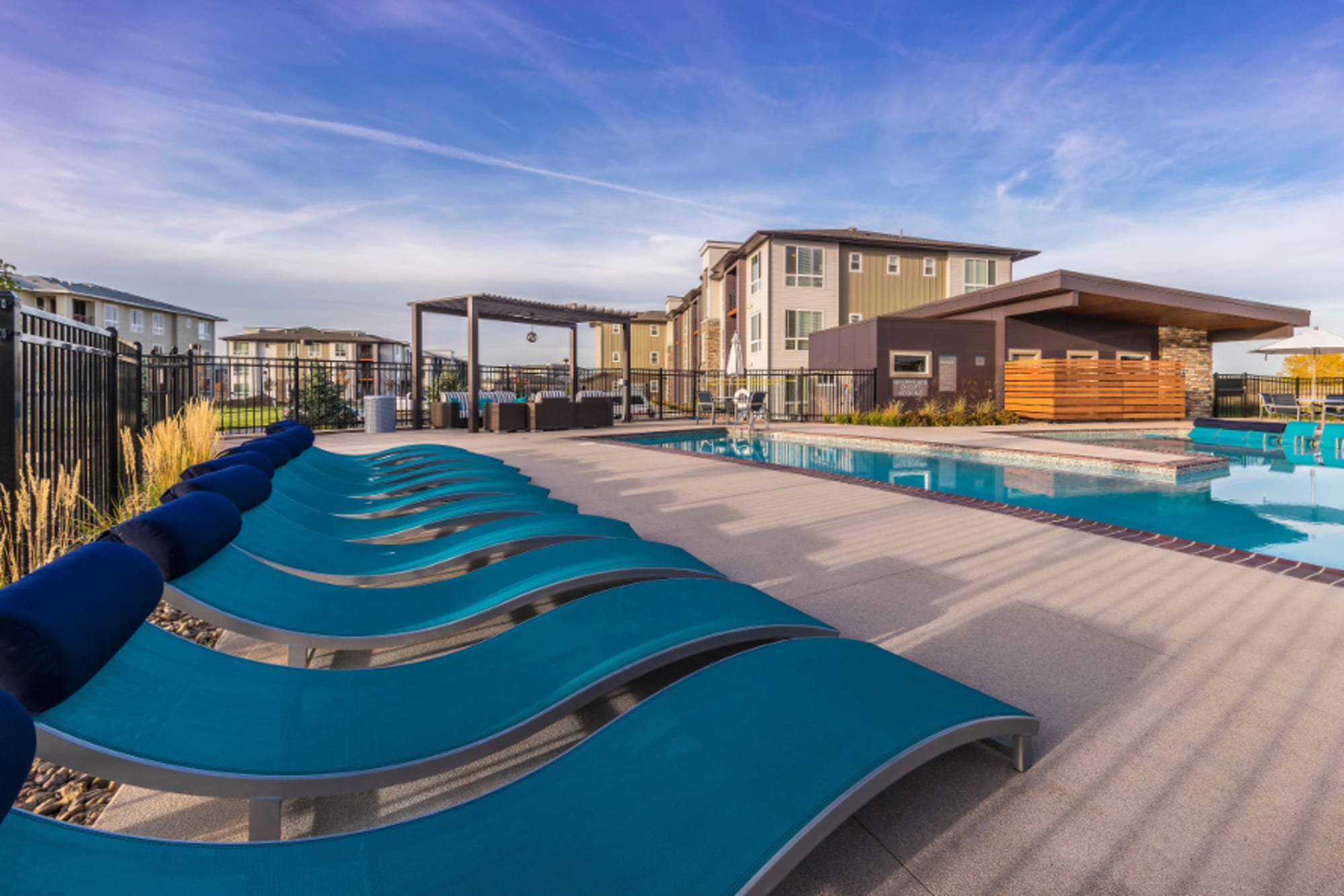 Swimming pool with in-pool loungers at Strata Apartments in Denver, Colorado