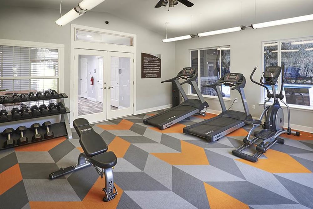 Fitness center with plenty of individual workout stations at Crossroads at City Center Apartments in Aurora, Colorado