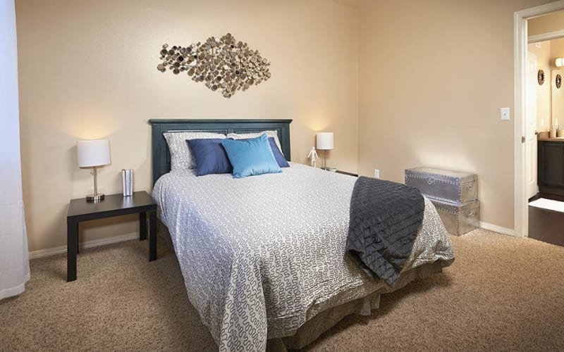 Spacious master bedroom with plush carpeting at Crossroads at City Center Apartments in Aurora, Colorado