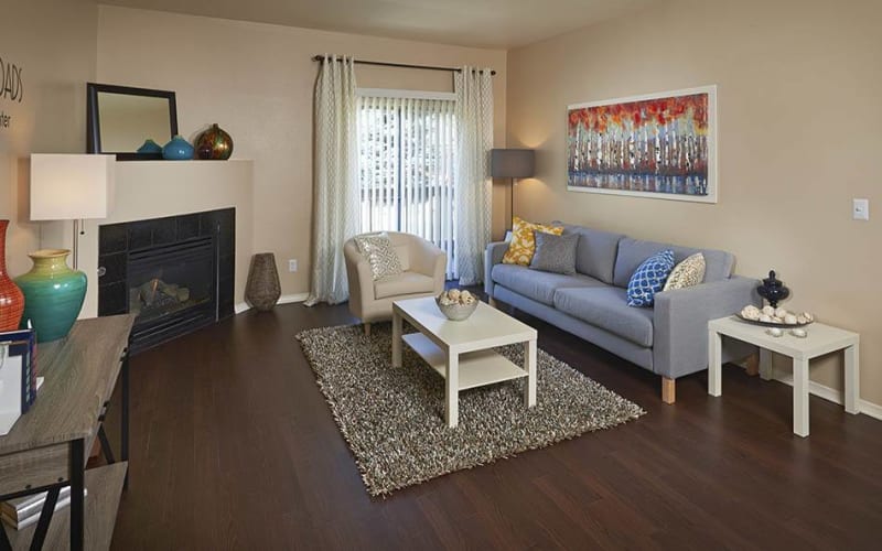Living room with a gas fireplace at Crossroads at City Center Apartments in Aurora, Colorado