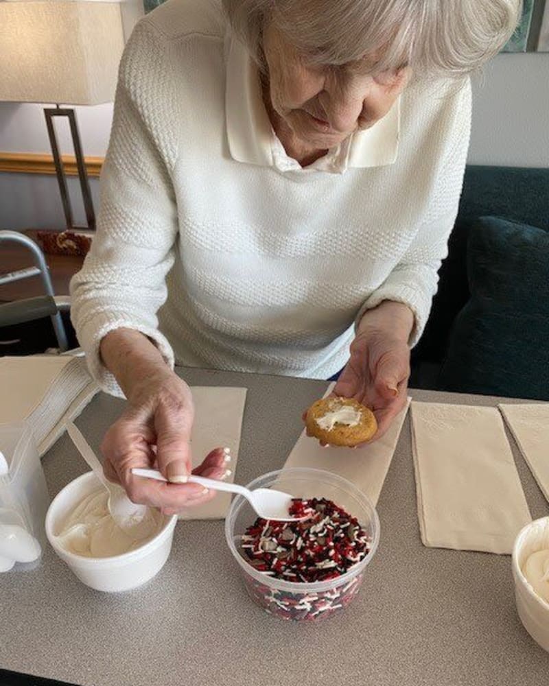 Resident decorating a pastry at Apple Creek Place in Appleton, Wisconsin