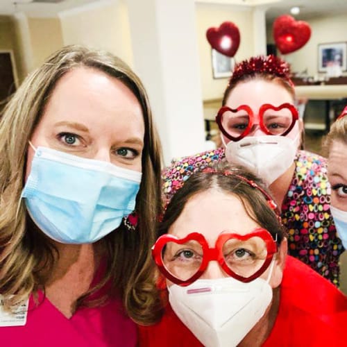 Resident with caregivers decked out in Valentines day props at Madison House in Norfolk, Nebraska