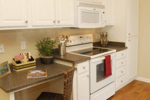 Kitchen with white cabinetry and appliances at Villas At Villaggio in Modesto, California